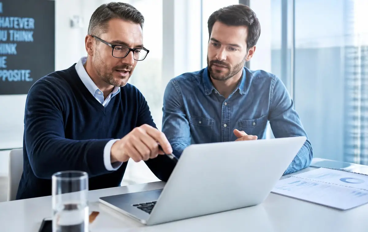 Advisor and business owner reviewing profitability figures together